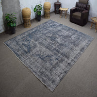 Angled view of large overdyed rug emphasizing subtle shading and modern minimalist character
