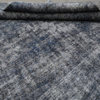 Edge detail of hand knotted overdyed Persian rug with visible binding and tonal depth
