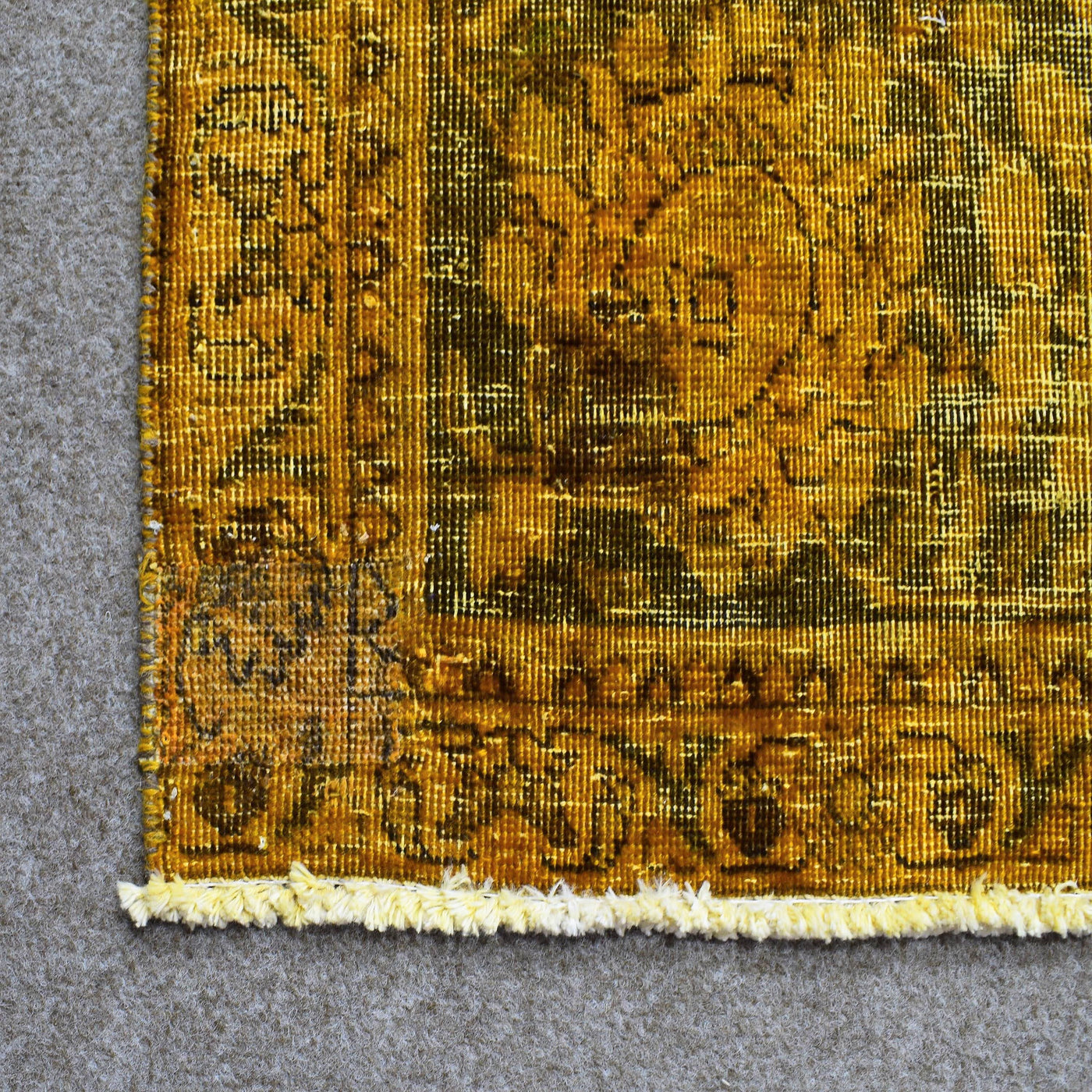 Backside of overdyed vintage Persian rug showing traditional hand knotted construction
