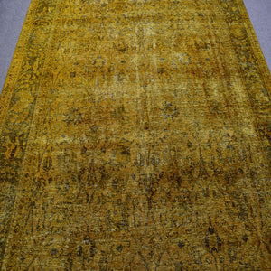 Overdyed Persian rug with antique distressed look and warm mustard tonal variations

