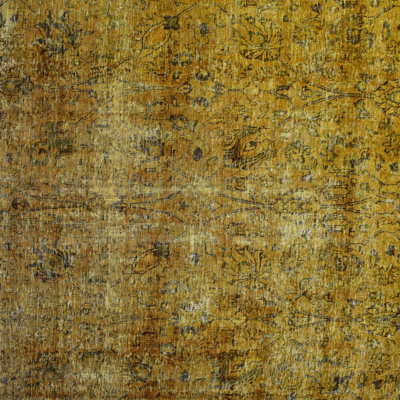 Close-up of overdyed vintage Persian rug showing textured wool pile and mottled gold tones
