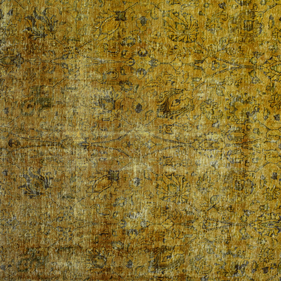 Close-up of overdyed vintage Persian rug showing textured wool pile and mottled gold tones
