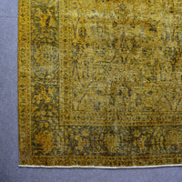 Detailed surface view of mustard overdyed Persian rug highlighting worn vintage patina
