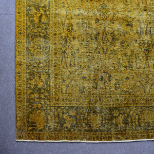 Detailed surface view of mustard overdyed Persian rug highlighting worn vintage patina
