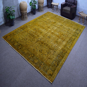 Angled view of large overdyed rug emphasizing color depth and distressed character
