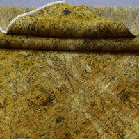 Edge detail of hand knotted overdyed Persian rug with visible binding and tonal shading
