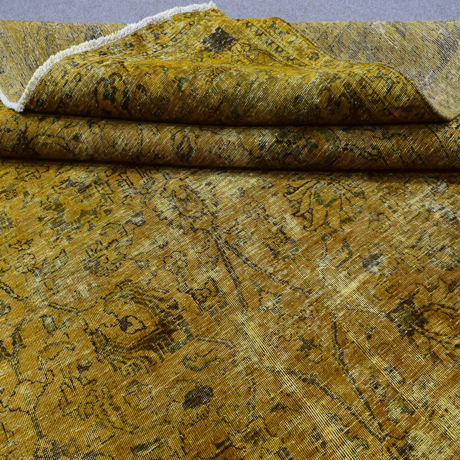 Edge detail of hand knotted overdyed Persian rug with visible binding and tonal shading
